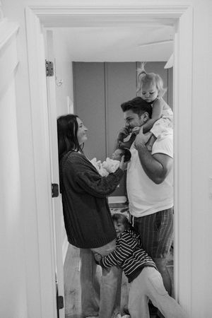 A split screen black and white image shows a sequence of a couple dancing together at home.