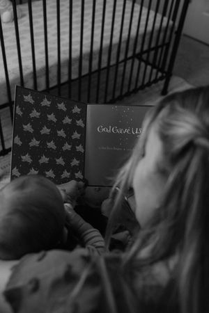 A black and white photo series showing someone reading a book in bed at night.