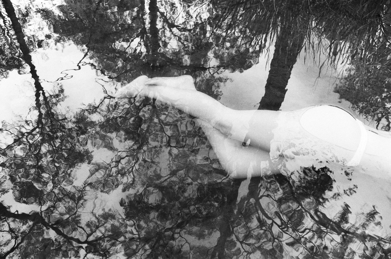 Feminine figure in water surrounded by florals – soft film tones captured in Lesmurdie Falls WA

Maria Guzman | Perth Photographer