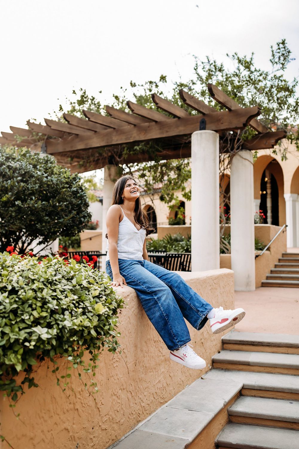 Series of photos showing person walking on outdoor stairs before appearing to float or jump through pergola-covered space.