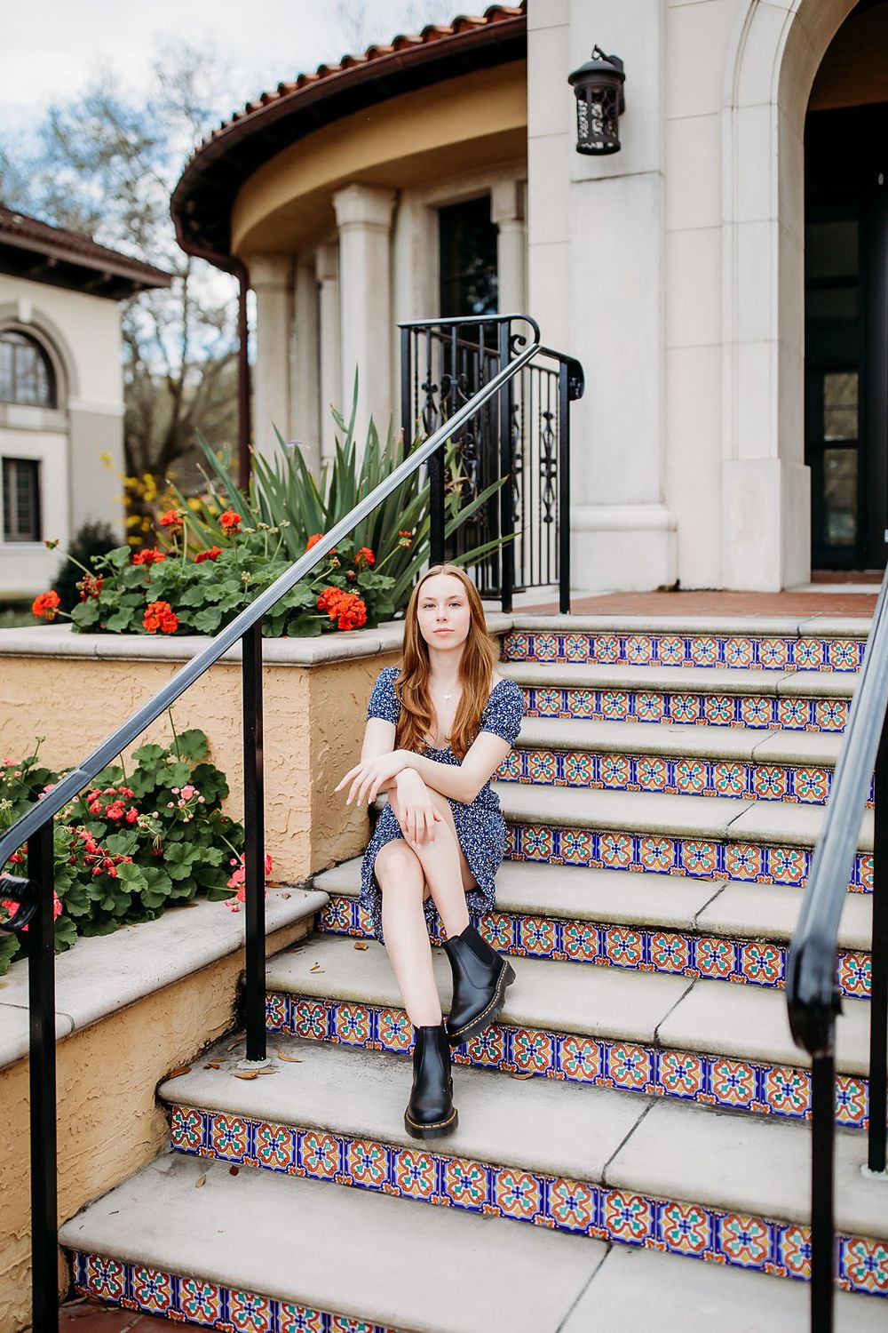 A sequence of images showing someone sitting and posing on outdoor decorative tiled stairs of a Spanish-style building.