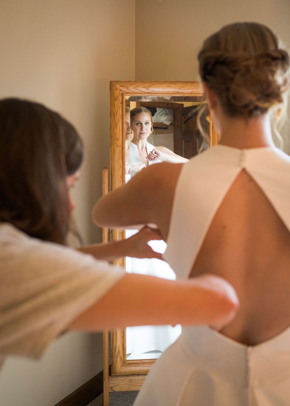 A sequence of getting ready shots showing someone adjusting a tie in front of a mirror.