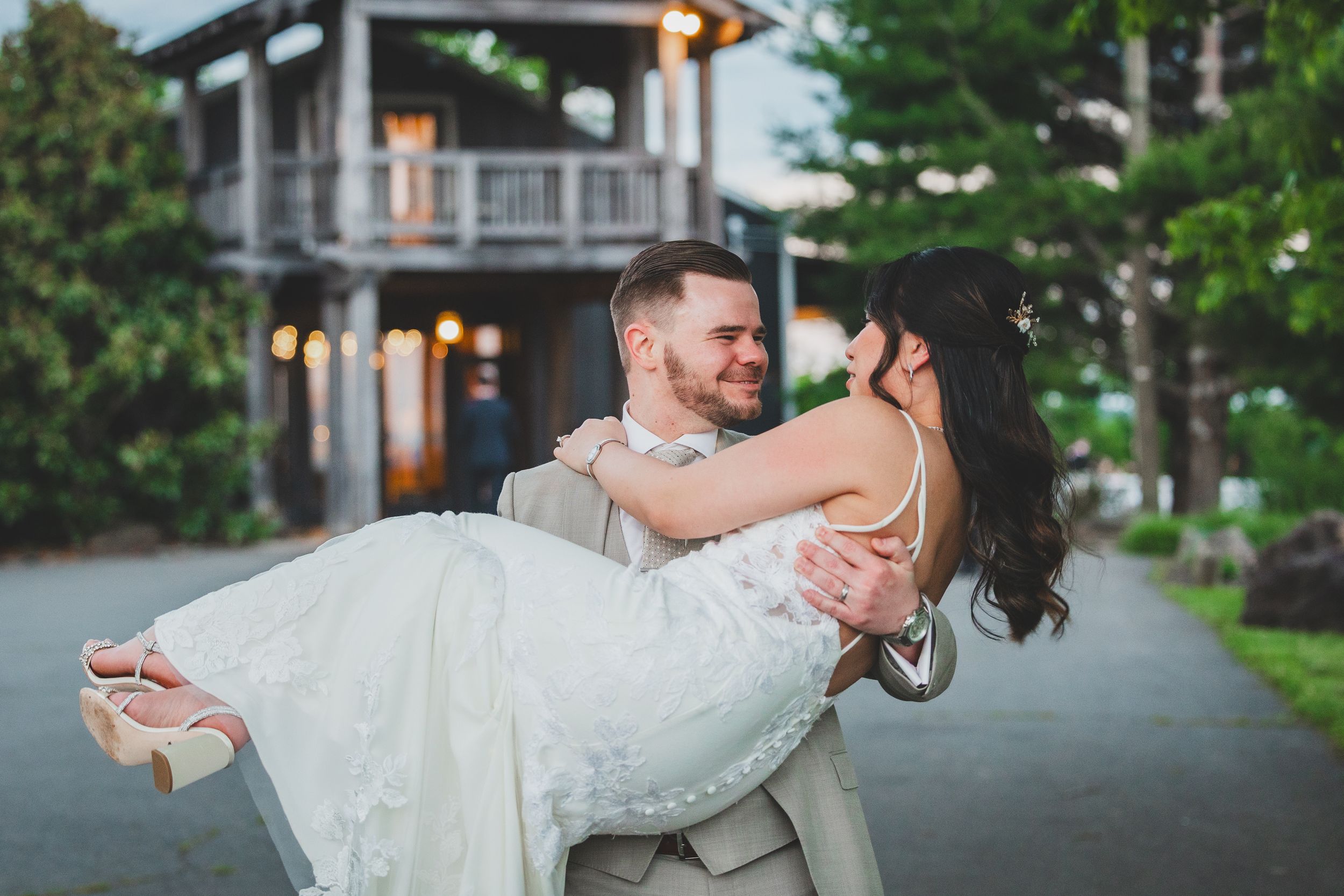 A romantic scene of a couple dancing during an intimate wedding celebration at twilight.