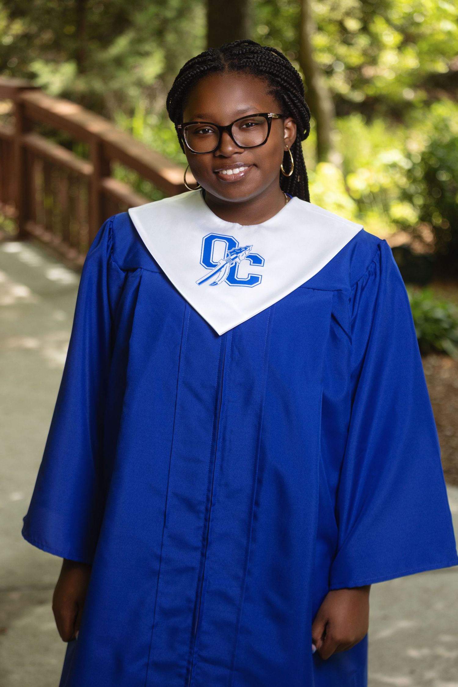 Graduation portraits in a royal blue cap and gown showing multiple poses outdoors.