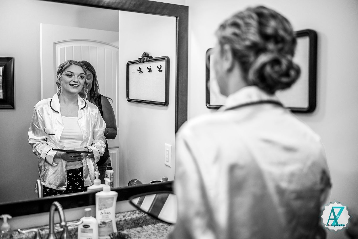 Black and white wedding photography series showing candid moments of bridal preparation and dress details.