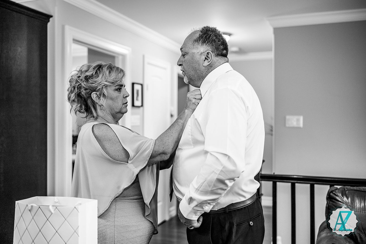 A sequence of black and white images showing tender dance moments at an indoor venue.