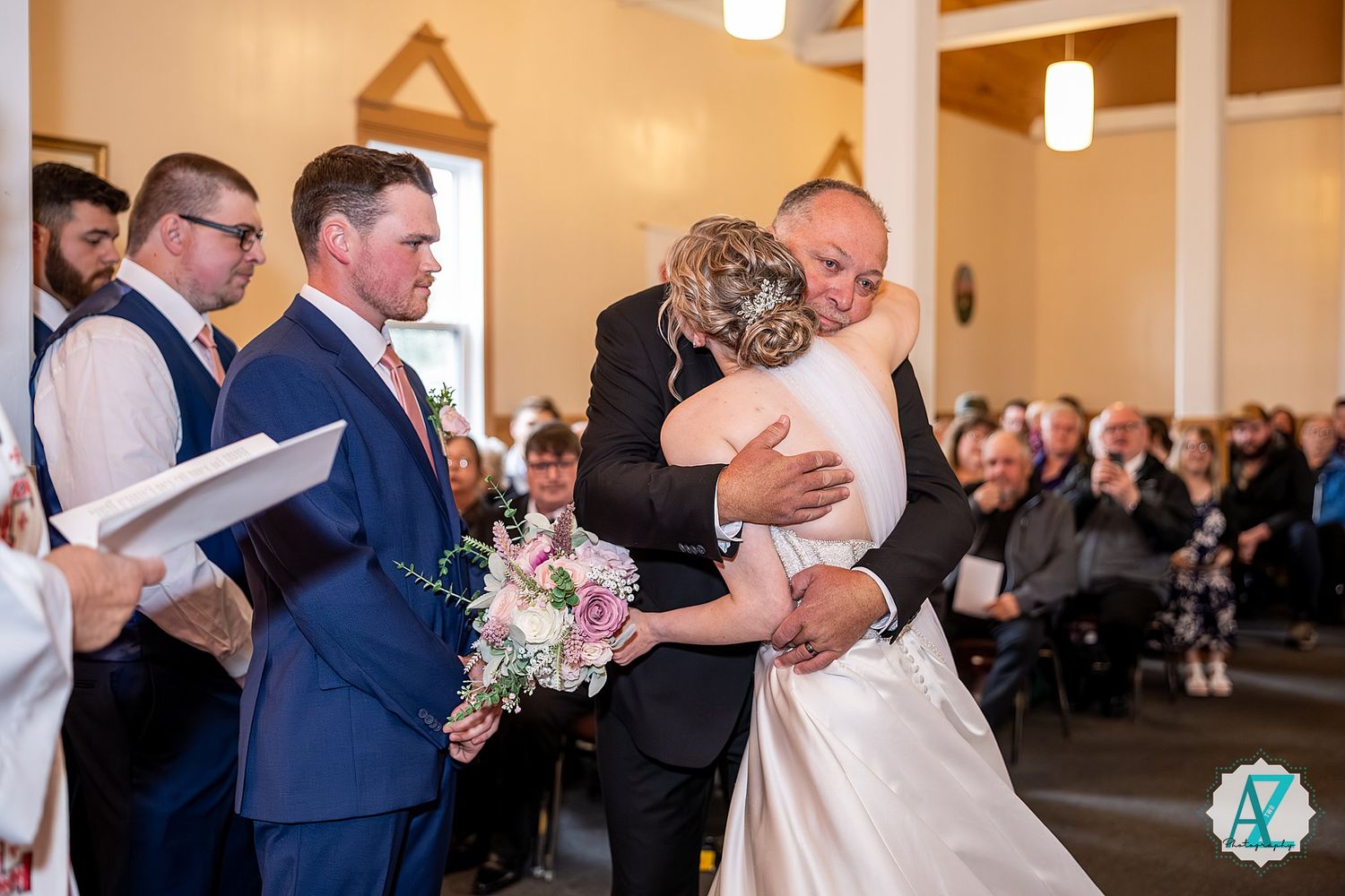 A joyful couple shares their first dance at their wedding reception surrounded by guests and twinkling lights.
