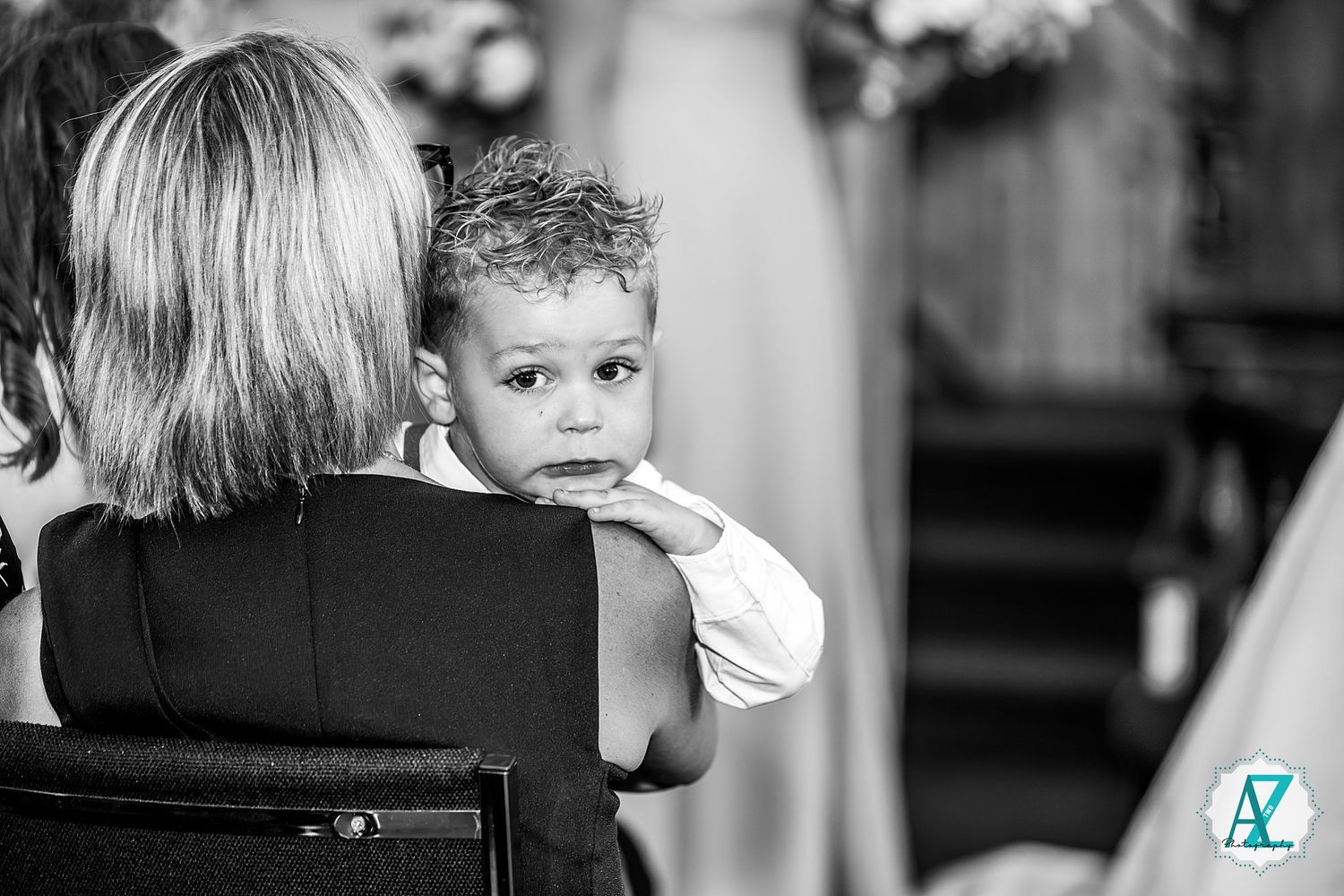 A black and white photo sequence shows various candid moments between two figures in chairs at an indoor event.