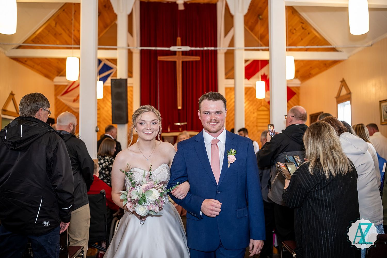 A glorious church interior decorated for a wedding ceremony with long hallways and elegant lighting.