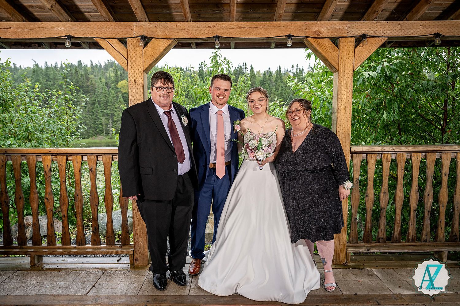 Family gathering on a covered wooden patio with rustic beams and lush greenery in background.