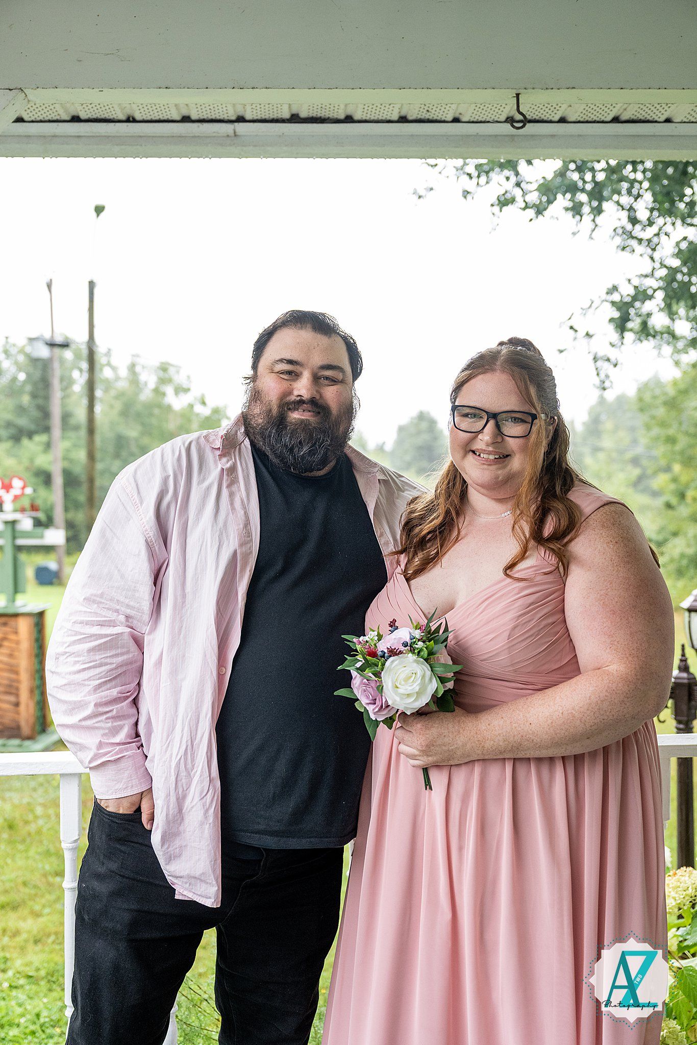A couple in pink and black formal attire pose together for a series of outdoor wedding party photos.