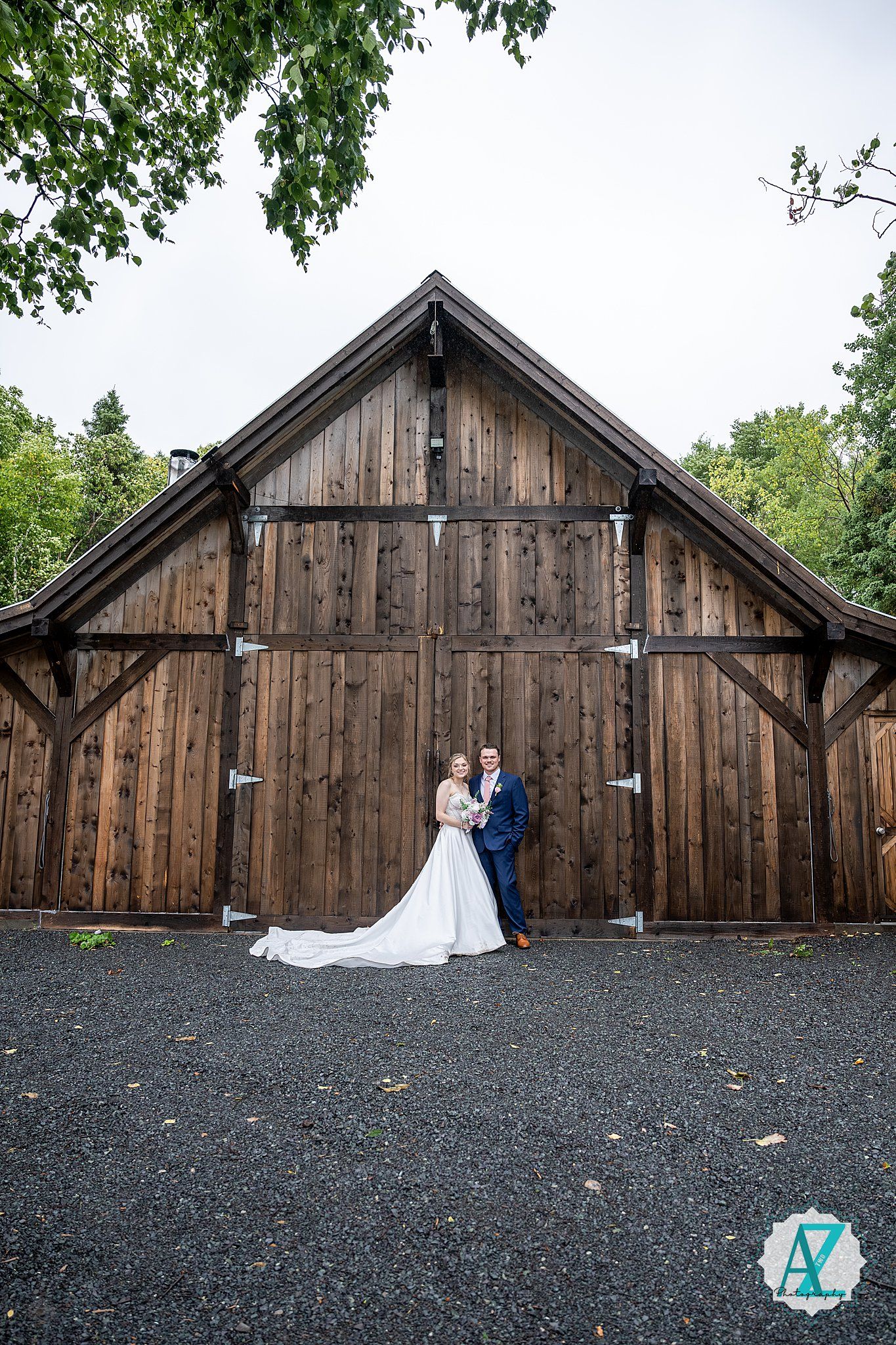 Wedding couple poses in sequence against rustic wooden barn backdrop with gravel ground.