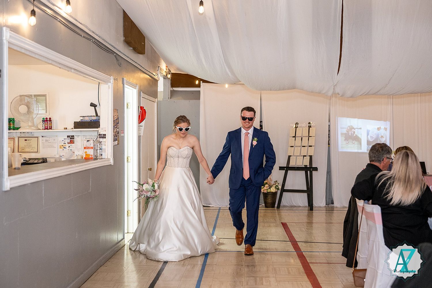 Wedding venue panorama showing a bright white reception hall with elegant lighting and decorative details.