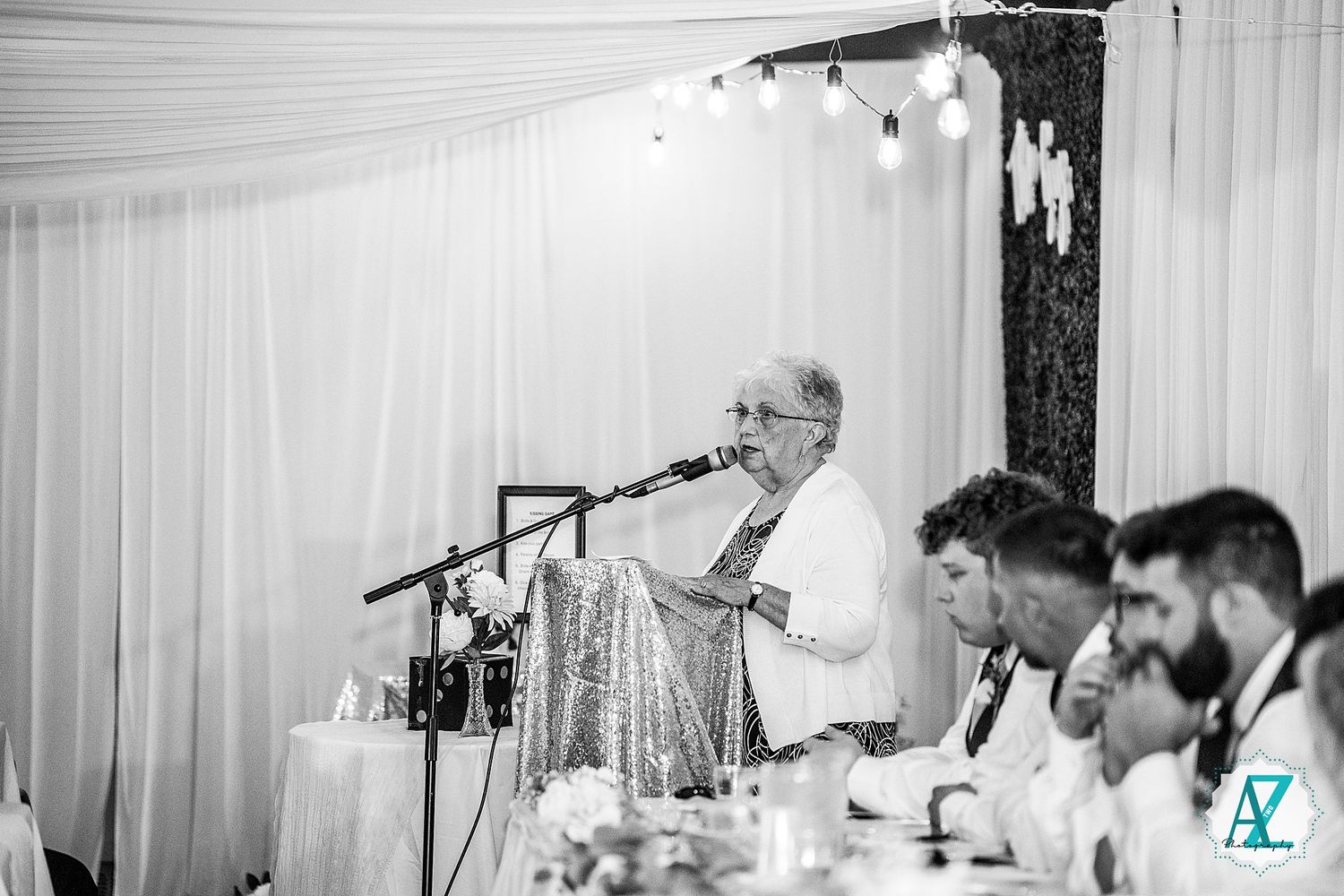 Wedding reception hall with white draping and banquet tables set up for a formal celebration.