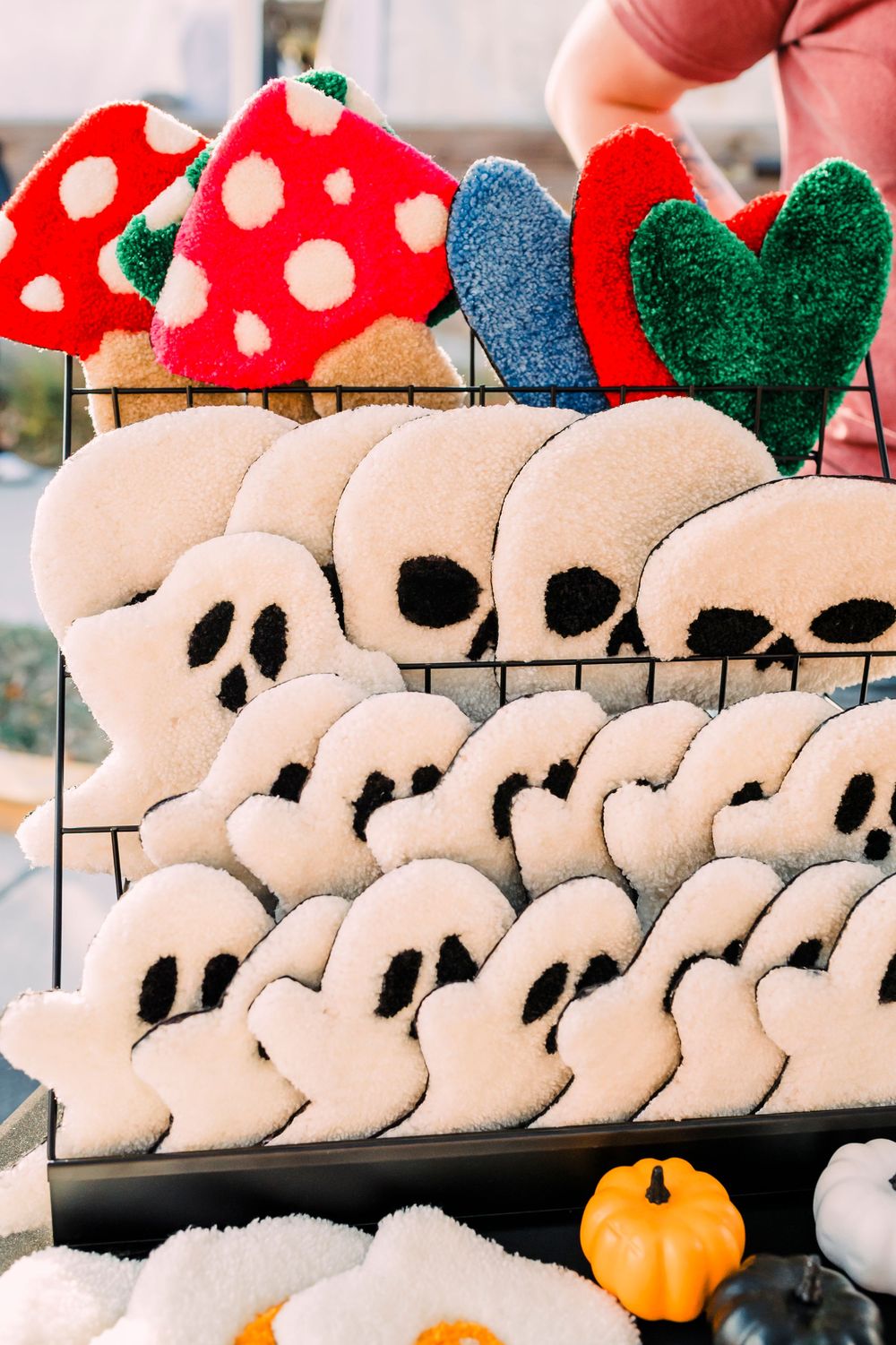 Display of plush Disney-themed holiday hats with red and white polka dot designs lined up in rows.