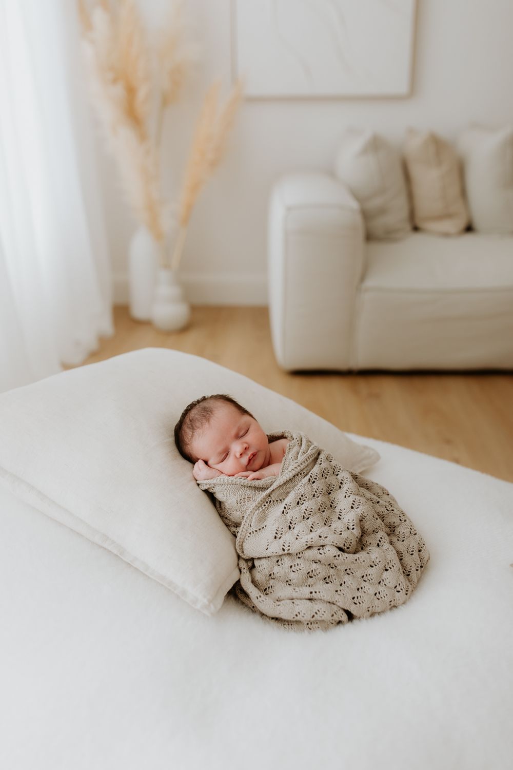 Adelaide newborn photographer captures a peaceful baby wrapped in soft blankets during a studio photography session in Tea Tree Gully.