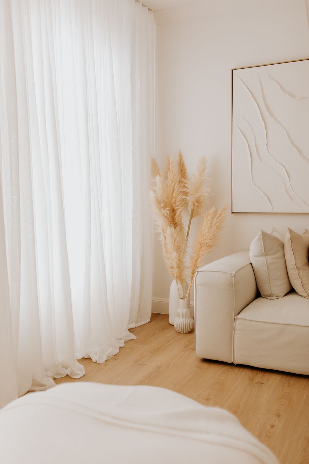 Photography studio in Adelaide featuring soft light, neutral backdrops and a mixture of textures with a couch for posing.