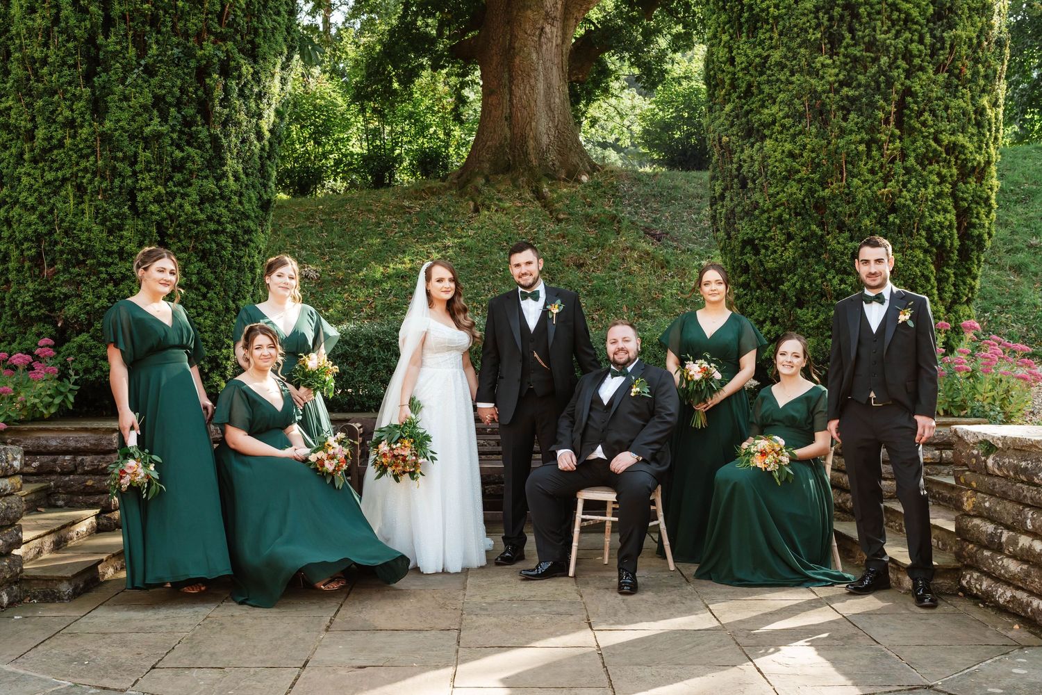 Coombe Lodge Wedding Photographer Zara Davis Photography vogue editorial group photo of bridal and groom party on patio Somerset