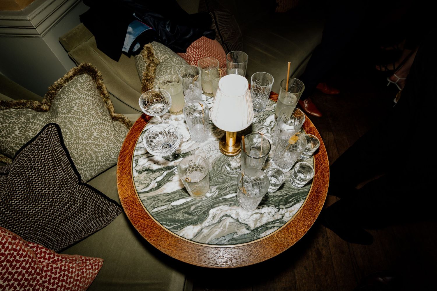 Elegant table settings with white linens and glassware arranged for a formal dining event.