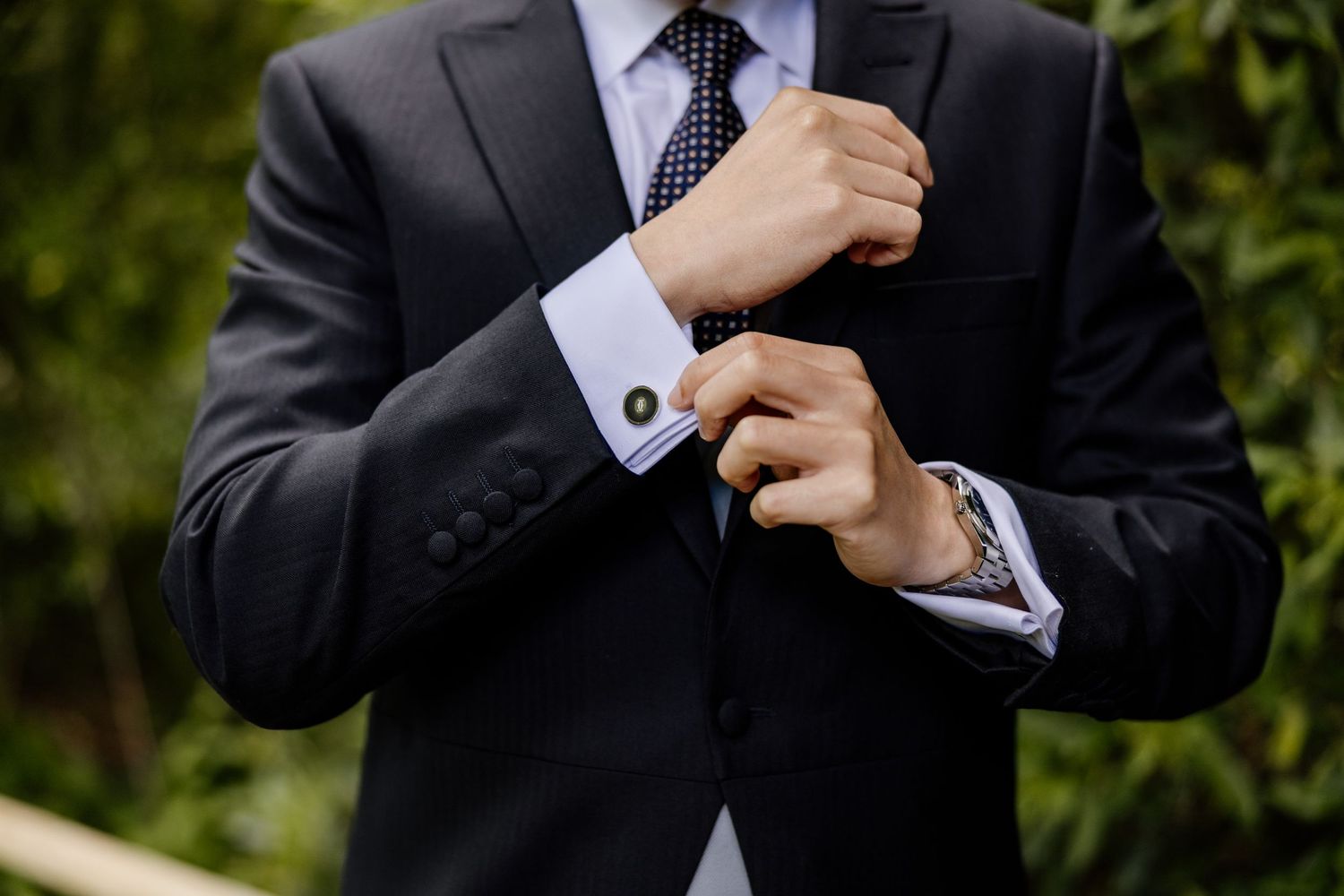 Close-up shots of formal suit details including tie adjustments and cufflinks.