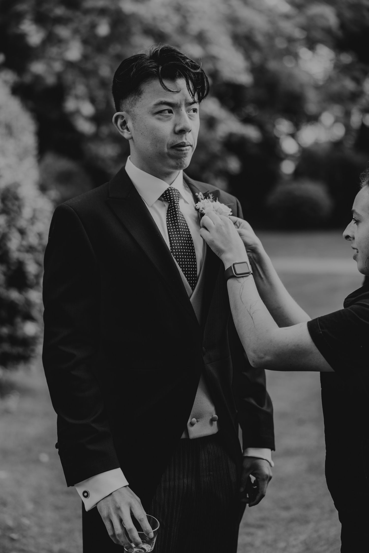 Black and white candid moments during wedding preparations.