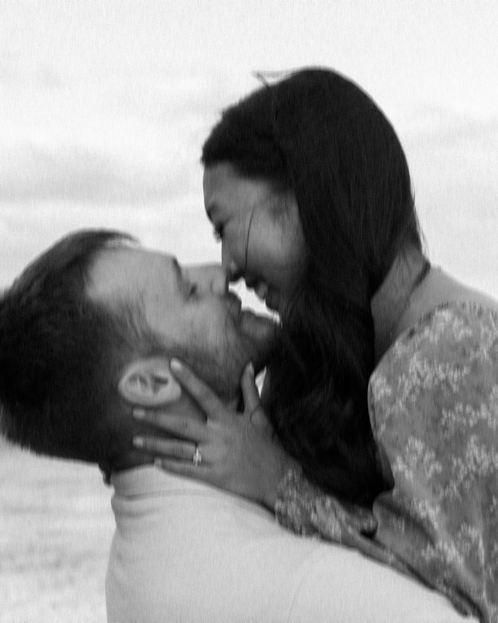 Two people kissing in sequence shown in black and white romantic photography.