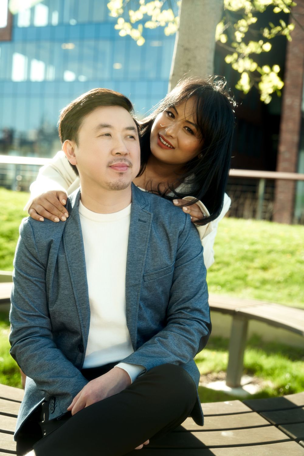 Affectionate couple sharing romantic moments together outdoors on a bench on a sunny afternoon. Engagement  in Williamsburge