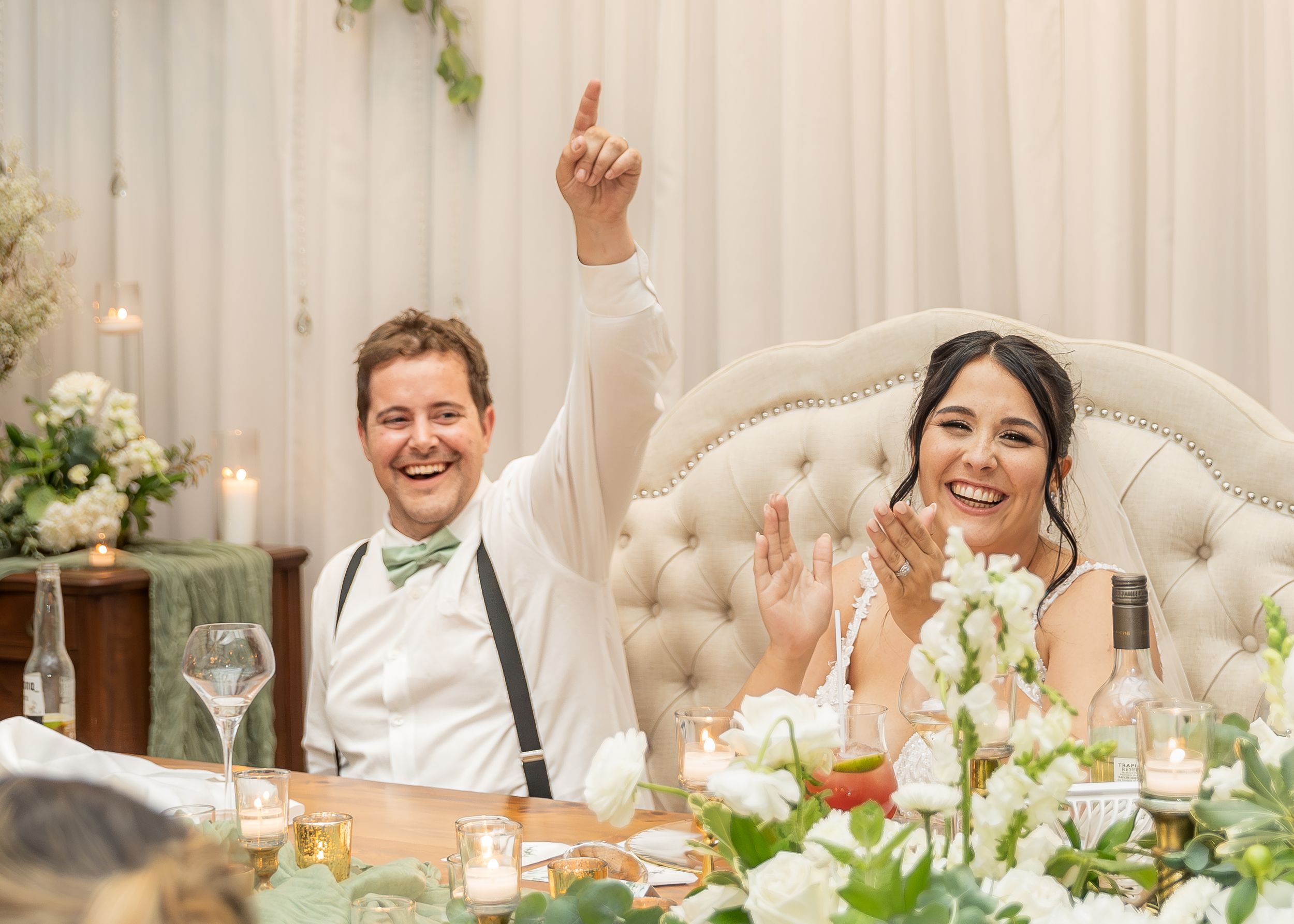 Bride and groom cheering during wedding reception speeches at Whispering Willow wedding. New Brunswick wedding photographer Moncton