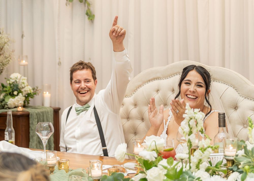 Bride and groom cheering during wedding reception speeches at Whispering Willow wedding. New Brunswick wedding photographer Moncton