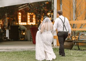 Bride and groom walking hand in hand towards Whispering Willow wedding venue event patio Moncton New Brunswick