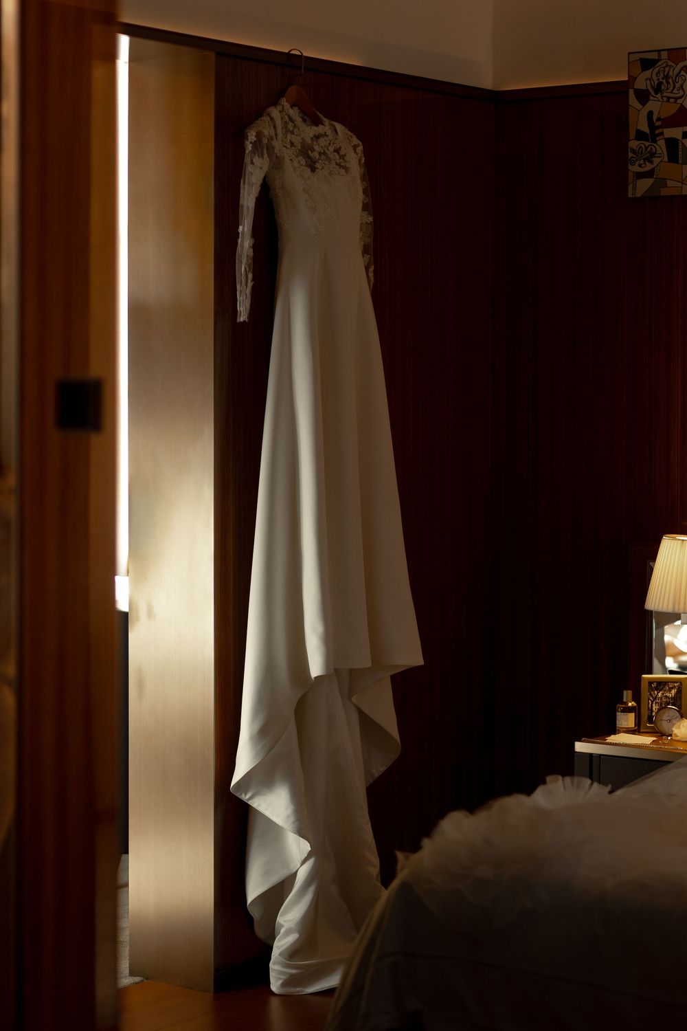 Dark interior room with white fabric draped against wall creating dramatic lighting and shadows.