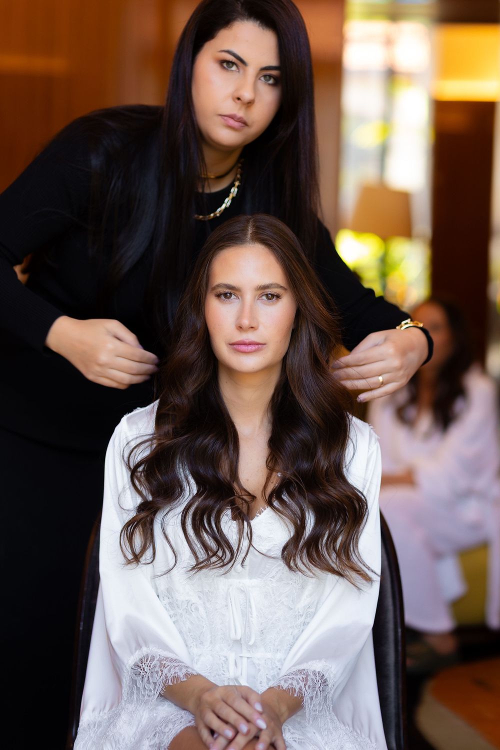 A hairstyling session in warm interior lighting with elegant styling tools and preparations.