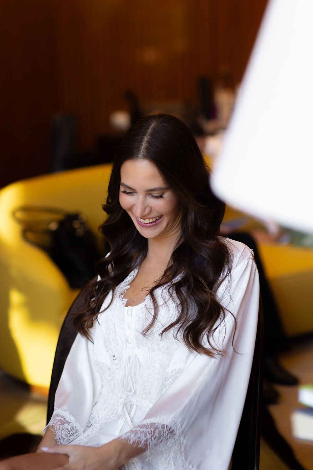 Woman in white blouse sitting with natural lighting and soft focus in a series of candid poses.