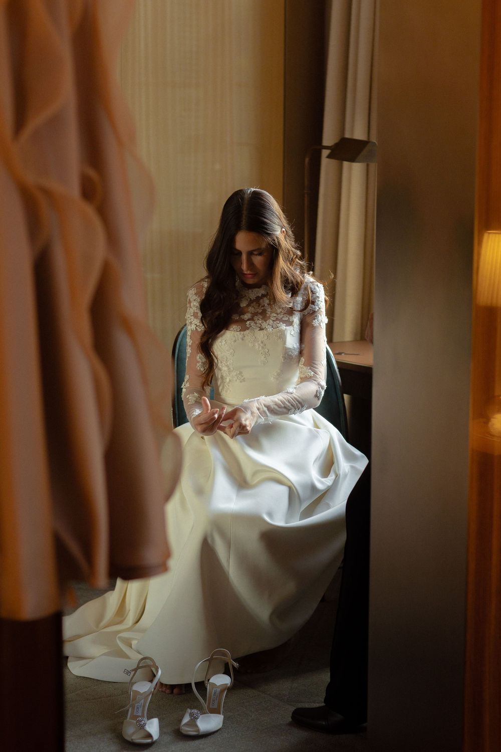 A series of five photos showing a bride in a white wedding dress adjusting their shoes near a doorway.