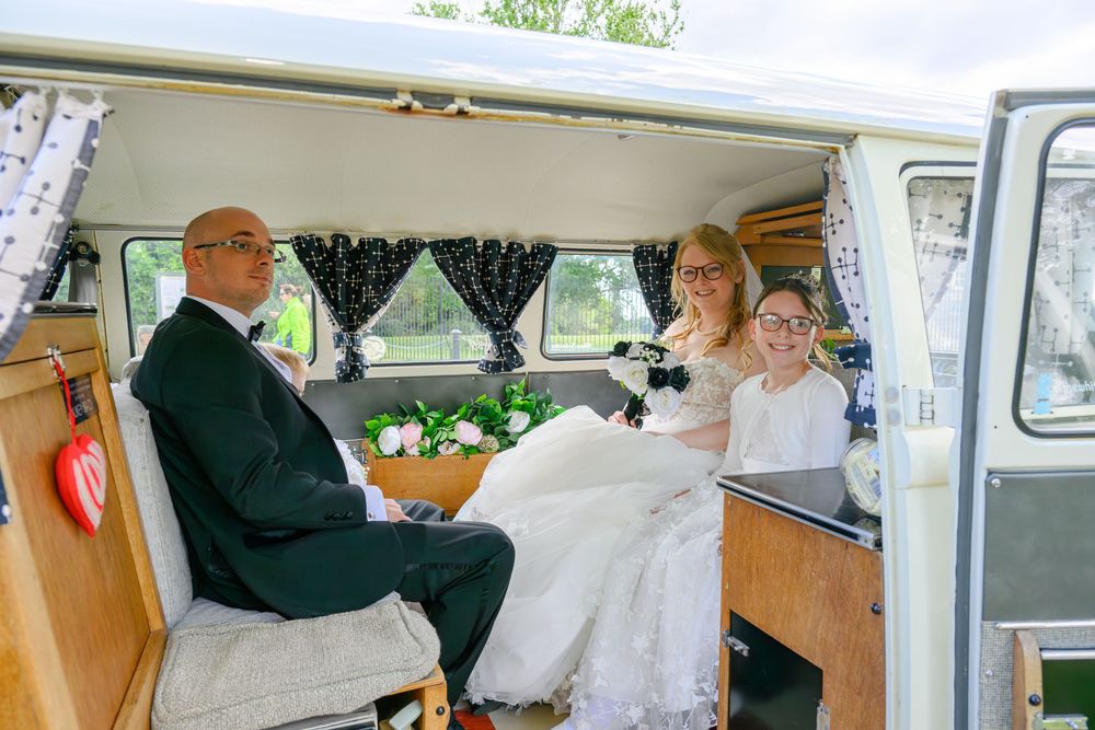 A classic white VW van decorated for a wedding celebration.