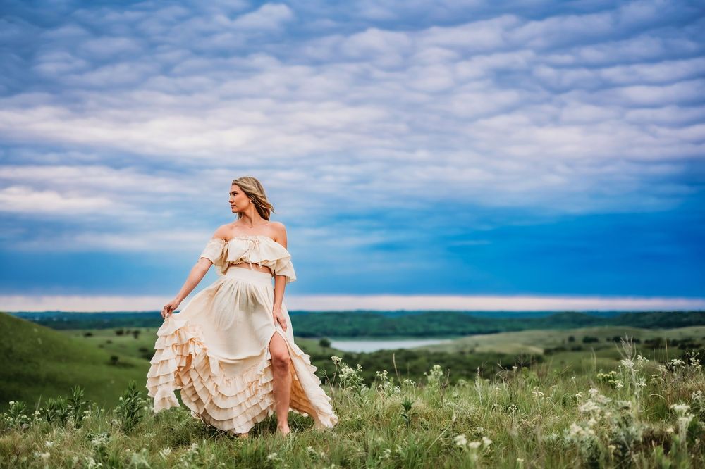 A series of panoramic landscape photos with green fields, blue skies, and white clouds forming a seamless banner.