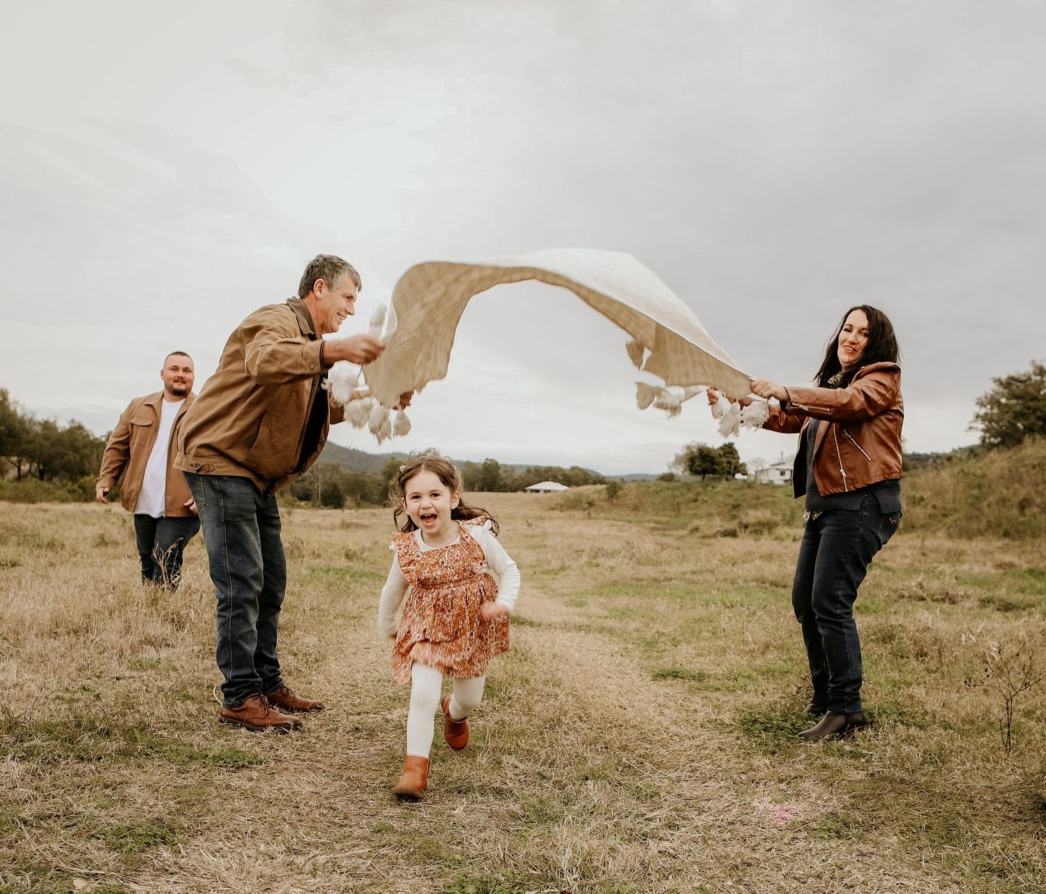 A series of candid lifestyle photos showing playful interactions between people in a golden grassy field at sunset.