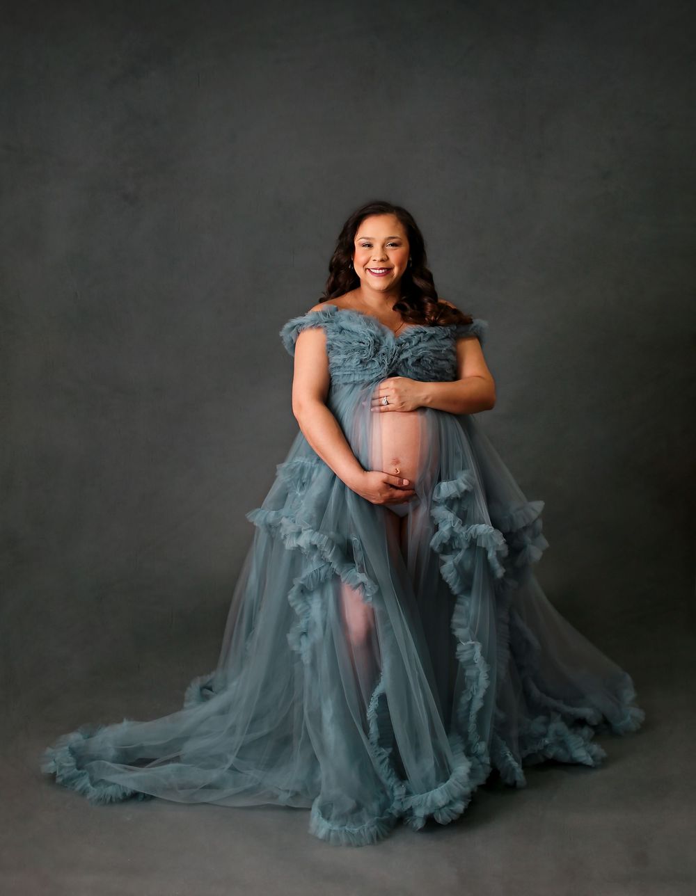 Mother in blue maternity dress posing for portrait session