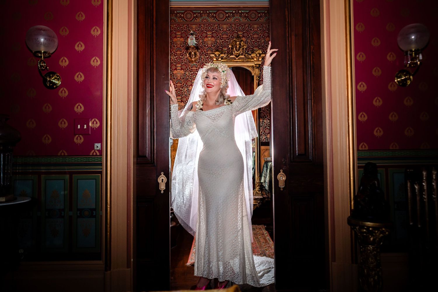 Dramatic sequence of poses in an elegant room with red wallpaper and ornate decor.