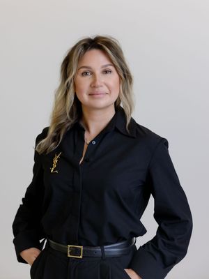 A figure in a black blazer and belt strikes multiple dynamic poses against a white background.