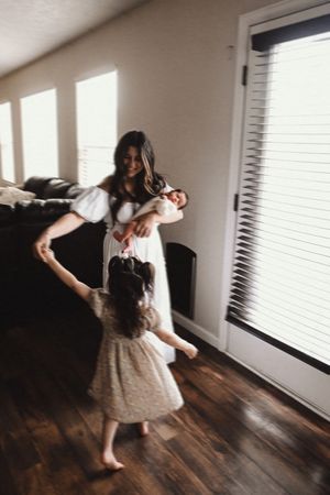 Dancing sequence in sunlit room with wooden floors and window light.