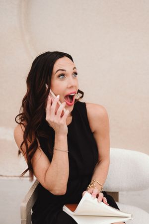 Woman in black top poses expressively in studio portrait series.