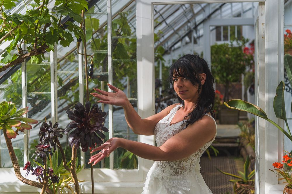 behind the scene bride showcasing succulant plant at heligan cornwall