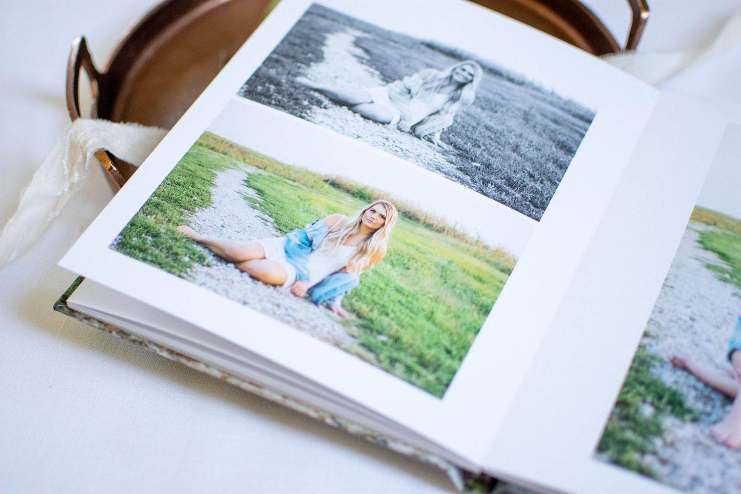 Open photo album showing black and white landscape photographs with natural scenery.