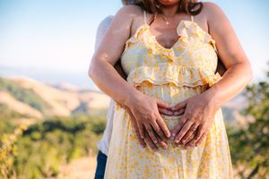 Five images show a yellow floral maternity dress being modeled outdoors during golden hour in a natural setting.