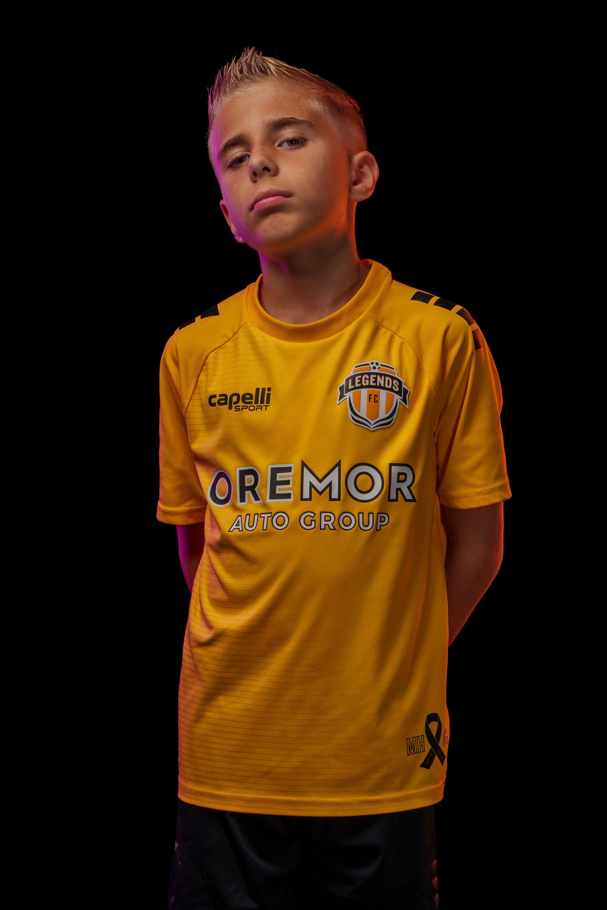 Soccer uniform showcase featuring yellow Legends FC jersey against black background.