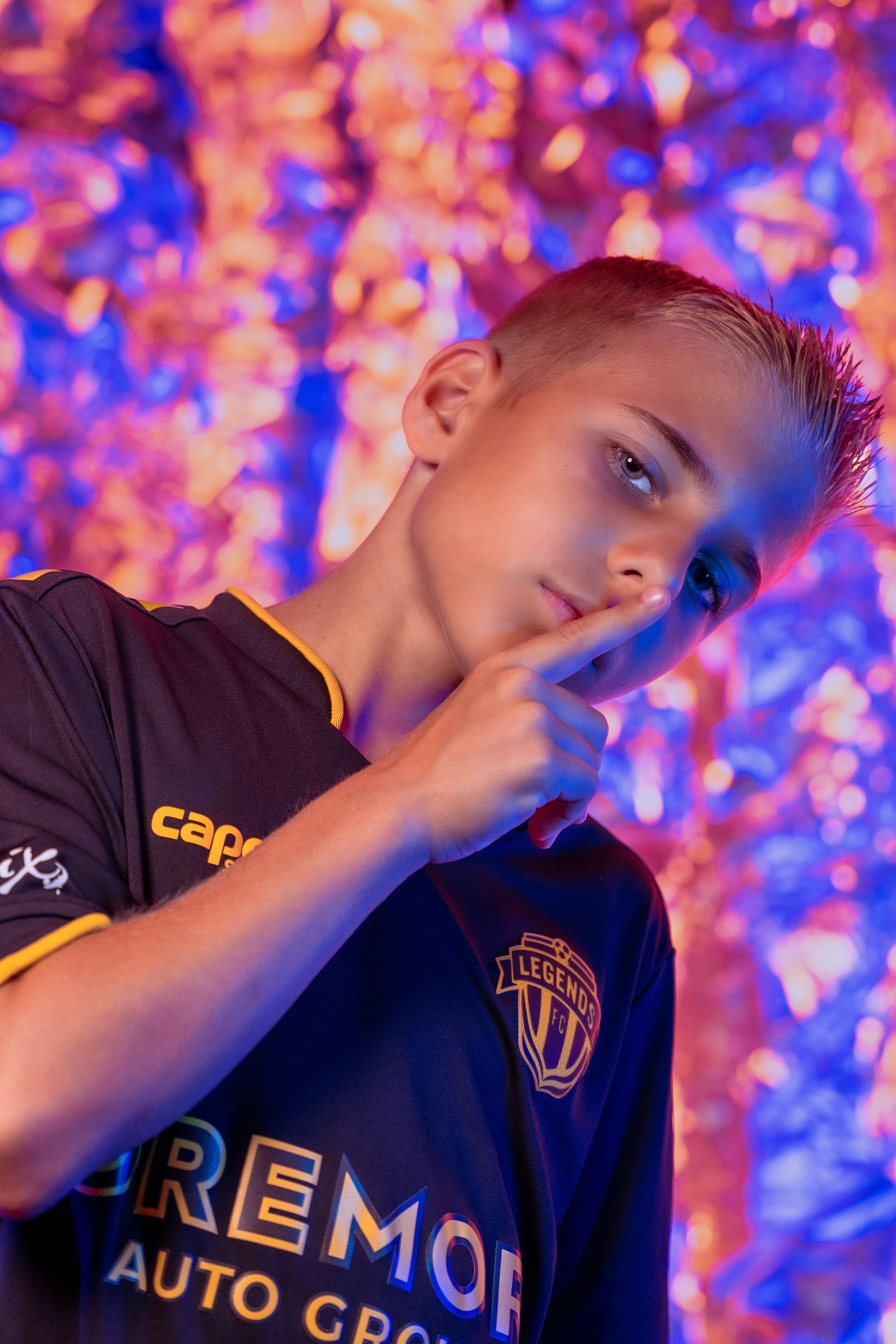 Dynamic action shots in Legends FC branded uniform against vibrant pink and blue background.