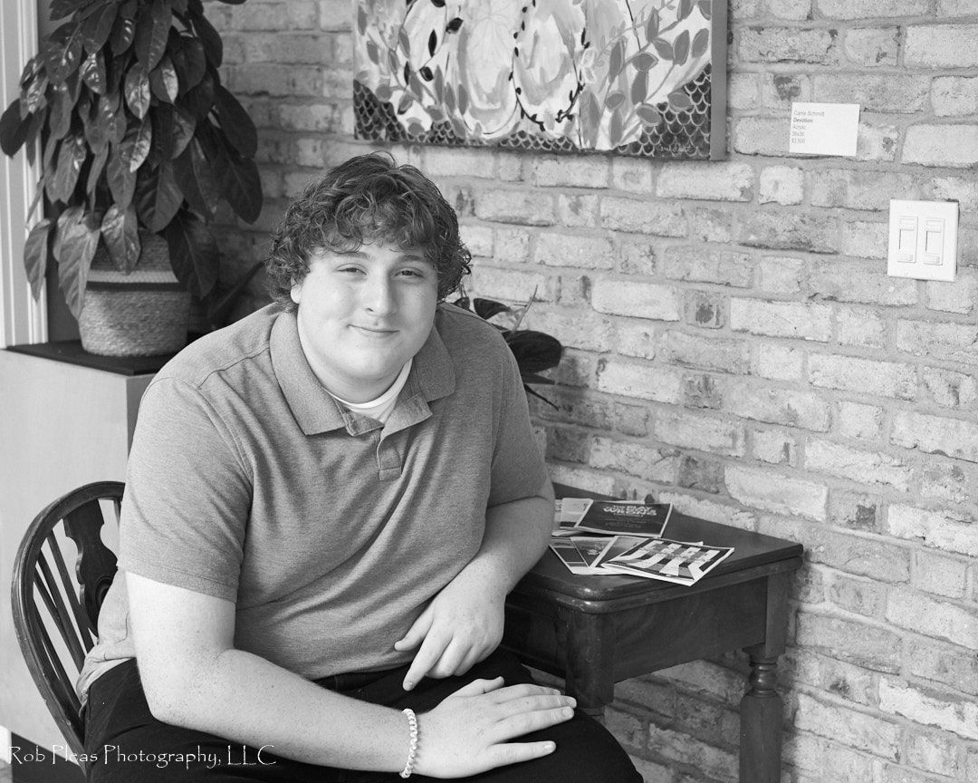 High school senior sitting at desk inside mansion at Lakewold Gardens in Lakewood, WA.