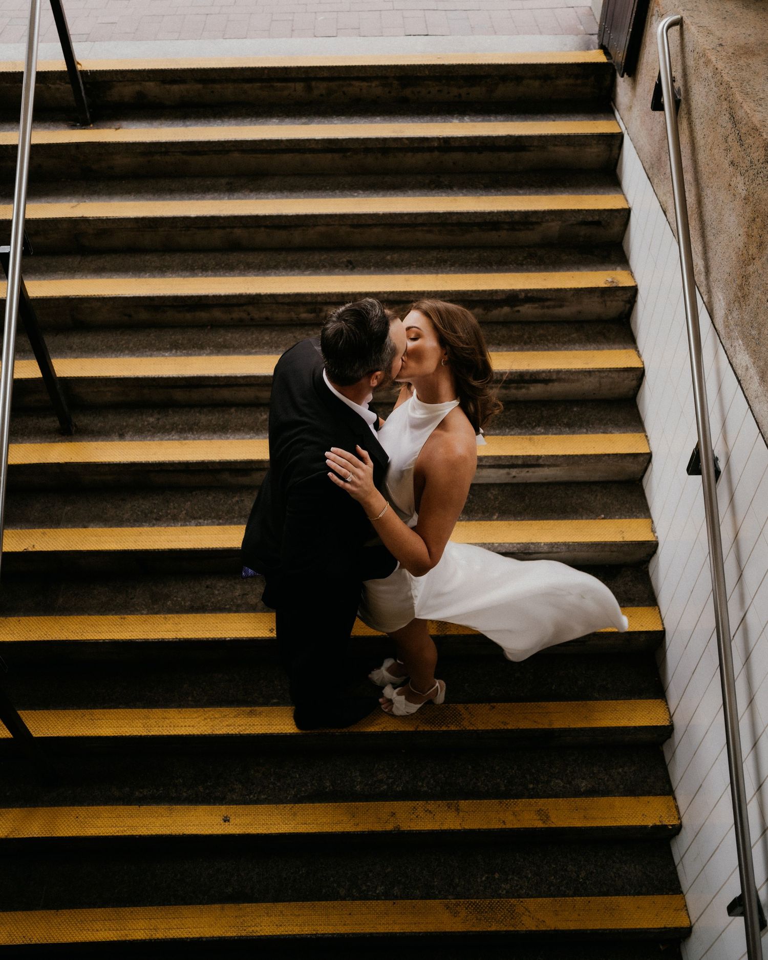 A timeline sequence of two people kissing and embracing on wooden steps with dramatic lighting and shadows.