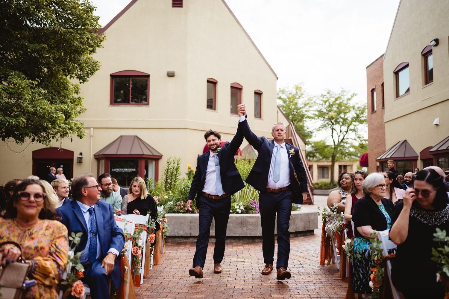 A panoramic collage of outdoor wedding moments showing joyful dancing and celebrating in a rustic venue setting.